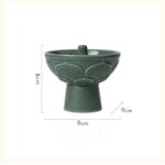 Green ceramic fountain with leaf pattern, measuring 8cm in height and 9cm in diameter, ideal for science decor and educational displays.