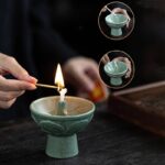 Person demonstrating a fireproof candle making kit with a lit candle and a small bowl, showcasing a science experiment or craft activity.