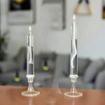 Two glass candles with magnetic spirals inside, used for educational science demonstrations and experiments involving magnetic fields and heat.