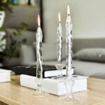Beautiful crystal candle holders with flickering flames, creating a cozy and sophisticated ambiance in a contemporary living space.