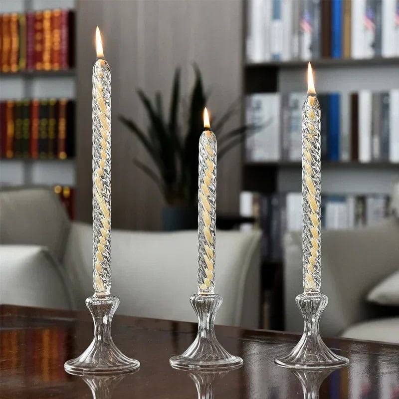 Elegant glass candle holders with lit candles on a wooden table in a cozy living room setting. Beautiful glass candle holders with lit candles, creating a warm and inviting atmosphere in a modern living room.