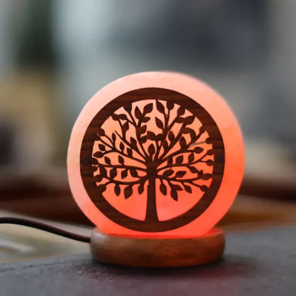 LED night light featuring a carved tree of life design, emits a warm glow, perfect for home decor or educational purposes.