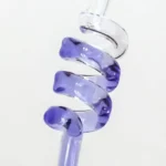 Close-up of a transparent and purple spiral glass sculpture with a smooth, glossy surface, showcasing intricate craftsmanship and vibrant color transitions.