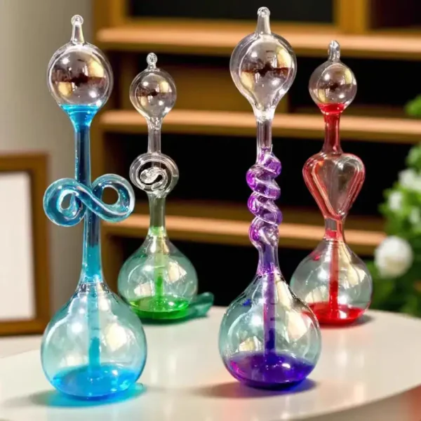 Vibrant glass science art sculptures featuring swirling and looped designs in blue, green, purple, and red, displayed on a white surface with a blurred background.