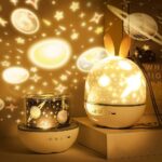Space-themed night light projector with bunny ears, projecting stars and planets onto walls, creating a cozy celestial atmosphere for kids' rooms.