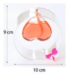 Heart-shaped liquid in a glass container with a pink bow.