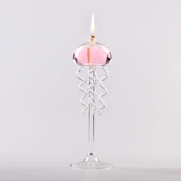 Elegant pink candle burning in a clear glass holder with a spiral stem, perfect for science decor and educational displays.