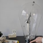 High-quality Tesla coil with a glass enclosure, demonstrating electrical phenomena and electromagnetic principles. Perfect for science enthusiasts and educational displays.