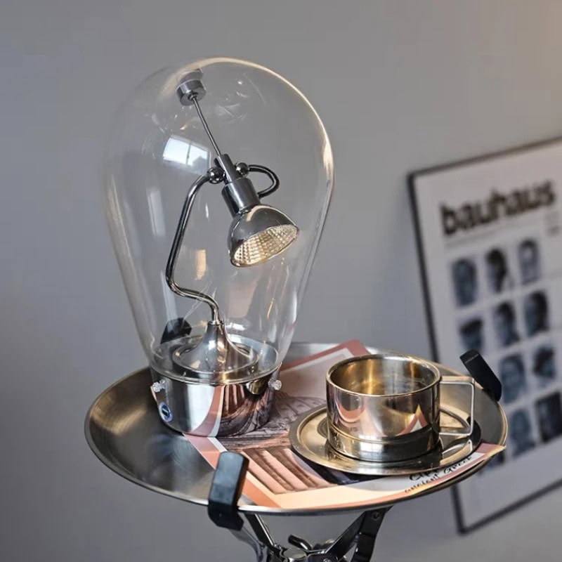 Light Bulb with Scientific Apparatus | Science Decor & Educational Toys A creative light bulb with a miniature scientific lamp inside, placed on a metallic tray with a cup and saucer, showcasing a blend of science and decor elements.