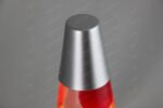Metallic lava lamp with red liquid and silver cap, modern science decor piece.
