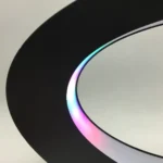 Circular mirror with integrated LED lighting displaying vibrant color transitions, ideal for modern decor and educational science displays.