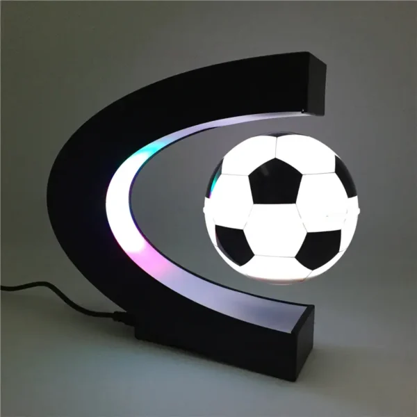 Modern football-shaped LED night light featuring a black and white soccer ball design, mounted on a crescent moon-shaped black frame, ideal for sports-themed decor.
