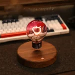 Decorative LED light bulb with heart-shaped filament on wooden base, ideal for science decor and educational displays.