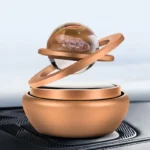 Miniature planetary model with a glass sphere and metallic base.