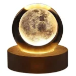 Moon globe lamp with a realistic lunar surface design, illuminated on a wooden base, creating a cozy and educational decorative piece.