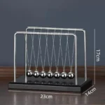 Classic metal Newton's Cradle with five swinging balls on a black base, demonstrating physics principles of momentum and energy transfer.