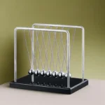 Classic Newton's Cradle with metal balls demonstrating physics principles, perfect for science education, office decor, and science enthusiasts.