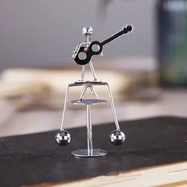 Small metallic guitar figurine made of shiny metal, perfect for science-themed decor or educational toy displays.