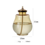 Clear glass oil dispenser with cork lid, measuring 7.7cm in height and 5.9cm in diameter, ideal for kitchen use and educational demonstrations.
