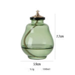 Transparent glass oil dispenser with a metal lid and a spout, measuring 7.7cm in height and 5.9cm in diameter, ideal for kitchen or educational science demonstrations.