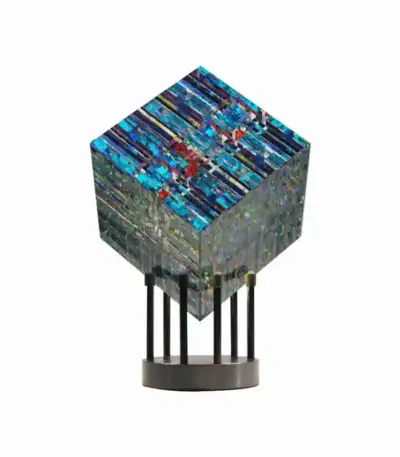 Modern geometric sculpture with vibrant blue and multicolored patterns on a black stand, perfect for science decor and educational display.