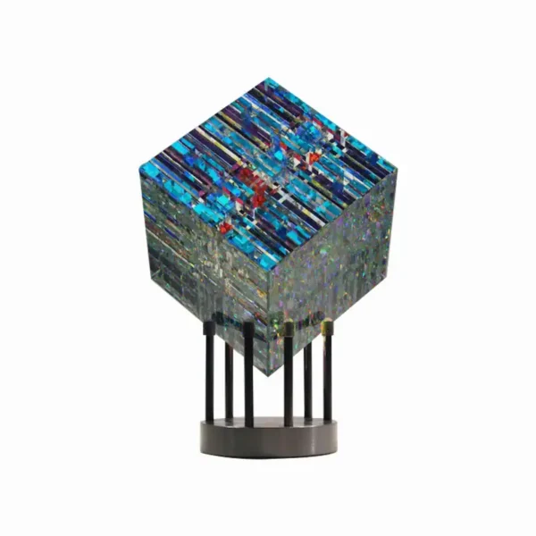 Modern geometric sculpture with vibrant blue and multicolored patterns on a black stand, perfect for science decor and educational display.