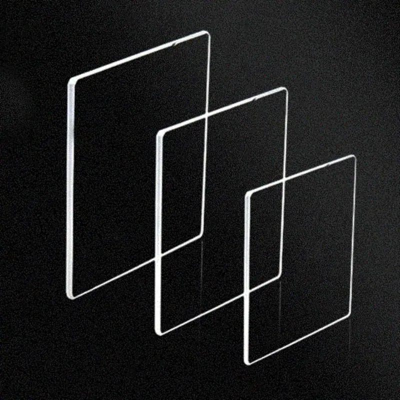 Transparent Geometric Phone Stands for Display and Decoration Set of three transparent acrylic phone stands of varying sizes, ideal for displaying smartphones or tablets on desks or shelves, combining modern design with functionality.