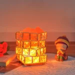 Illuminated cube lamp with orange glow, perfect for science-themed decor and educational spaces.