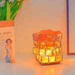 A decorative lamp made of glass cubes with a warm glow, perfect for science-themed decor or educational settings.