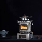 Small portable camping stove with visible flame, ideal for outdoor cooking and camping adventures.