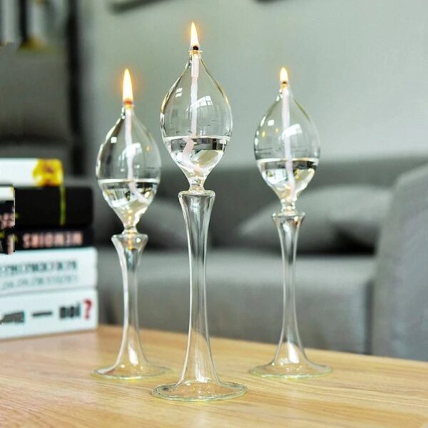 Elegant glass candle holders with floating candles on a wooden table.