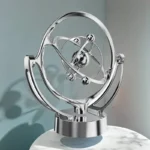 A sleek, metallic atom model sculpture representing atomic structure with orbiting electrons, perfect for science decor and educational display.