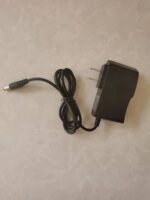 Power adapter with a black rectangular body and a two-prong plug, featuring a connected cable for powering electronic gadgets.