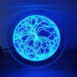 Illuminated globe displaying a lightning storm pattern with vibrant blue lightning bolts inside a clear spherical shell, perfect for science decor and educational purposes.