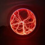 A vibrant red and orange lightning ball displaying striking electrical discharges inside a glass sphere, creating a captivating visual of natural electrical phenomena.