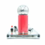 A clear image of a Tesla coil setup with a glass sphere on top, featuring a red insulator and metallic components, used for demonstrating high-voltage electrical phenomena.