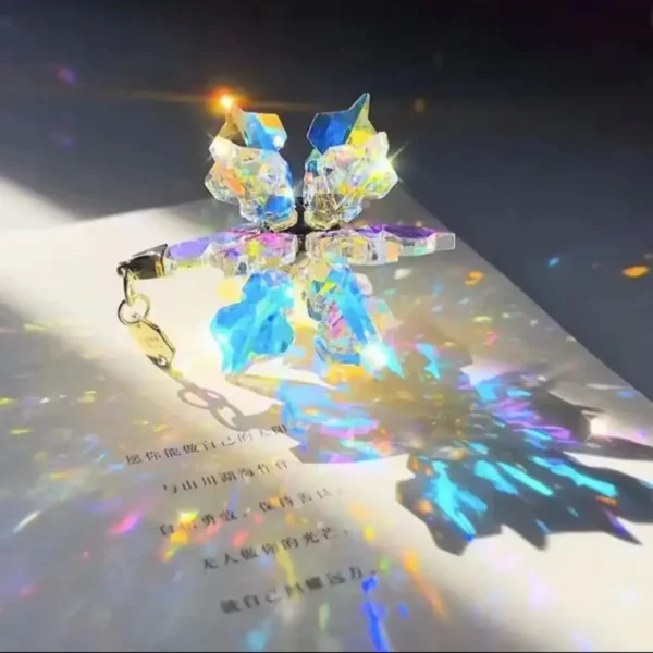 Vibrant crystal butterfly keychain casting colorful light reflections on paper.