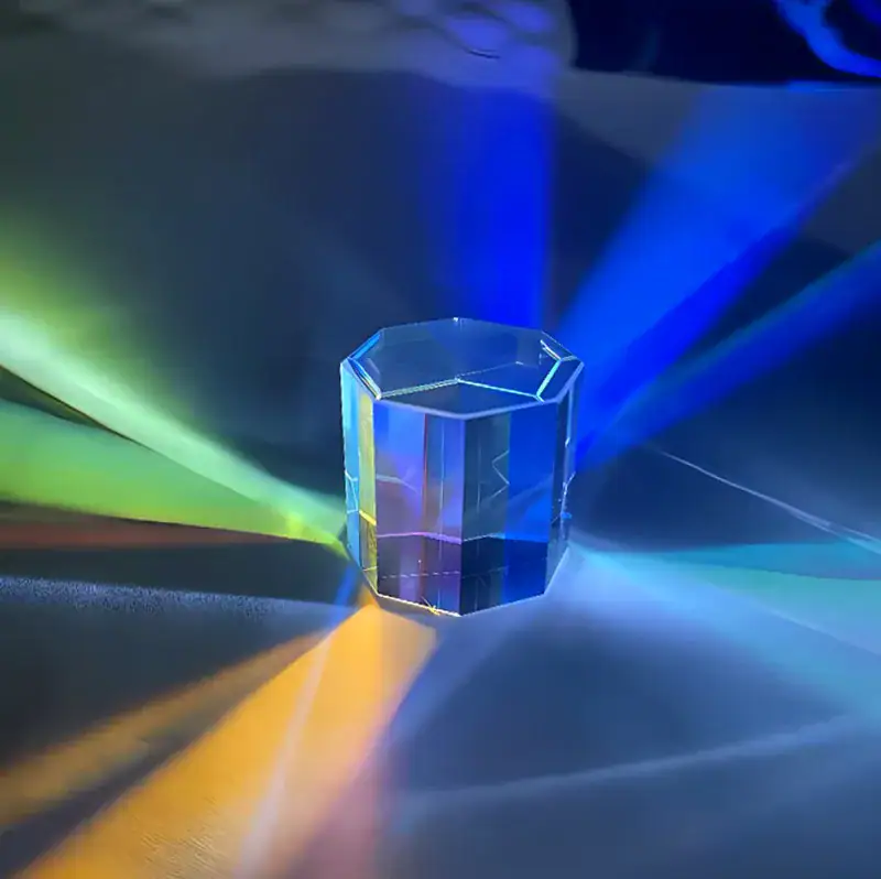 Transparent hexagonal prism with colorful light reflections and beams spreading outward, creating a vibrant and dynamic visual effect.