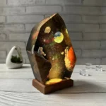 Decorative cosmic space lamp featuring an astronaut and planets scene.