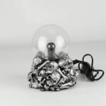 Unique skull-shaped lamp featuring a metallic skull base with a clear glass bulb on top, perfect for science-themed decor or educational settings.