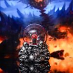 Decorative skull-shaped crystal ball with a red core, perfect for science-themed displays or Halloween decorations. Features intricate skull details and a glowing, mysterious appearance.