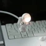 Cute astronaut LED lamp with glowing head, perfect for science-themed decor, study desk lighting, or as an educational toy for space enthusiasts.