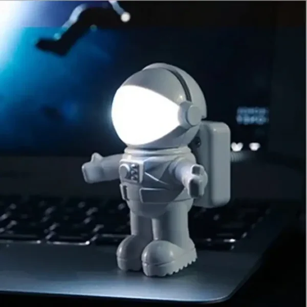 Cute astronaut-shaped LED night light with a glowing helmet, perfect for kids' rooms and science-themed decor.