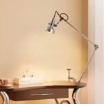 Vintage adjustable desk lamp with a metal arm and shade, perfect for reading, studying, or working at a desk. Features a flexible arm for directing light precisely where needed.