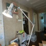 Industrial-style adjustable desk lamp with metallic finish and copper wiring.