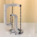 LEGO-style science pendulum model with chains and a frame.