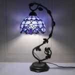 Antique Tiffany-style stained glass table lamp featuring a floral pattern and vibrant colors, perfect for adding a touch of elegance to any room.