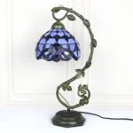 Elegant Tiffany-style table lamp with a blue stained glass shade and a decorative metal vine base, perfect for adding a vintage touch to any room.