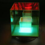Illuminated acrylic display case with multicolored lighting for science exhibits and educational displays.