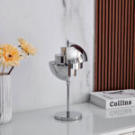 Stylish modern chrome desk lamp with adjustable arm, perfect for home or office decor, providing focused lighting for work or reading.